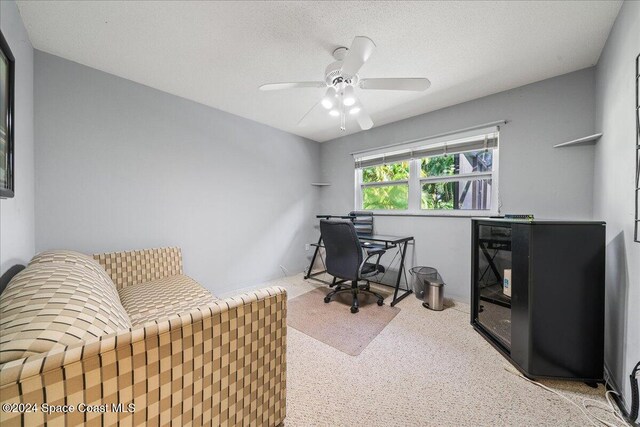 office with carpet flooring, a textured ceiling, and ceiling fan