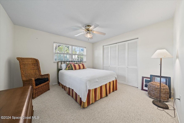 bedroom with ceiling fan, a closet, and carpet