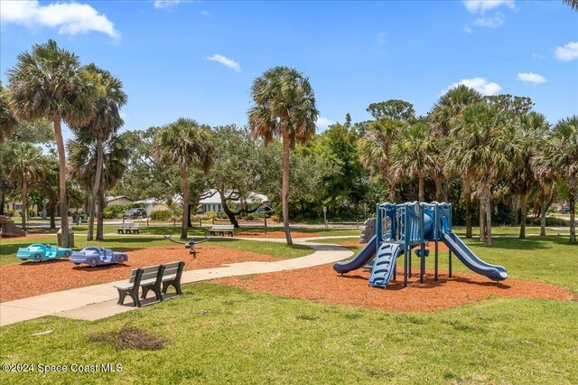 view of playground with a lawn