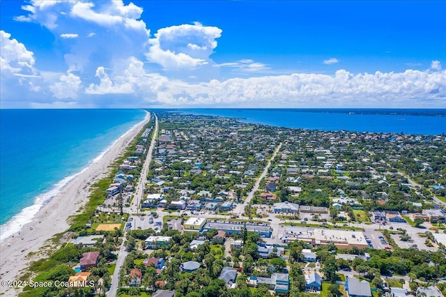 drone / aerial view with a water view and a view of the beach