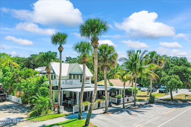 view of front of property with a porch and a balcony