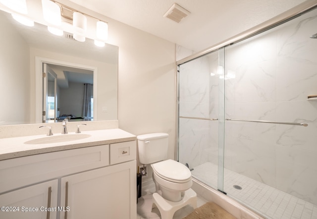 bathroom with vanity, toilet, and an enclosed shower