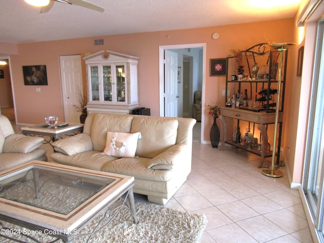 tiled living room featuring ceiling fan