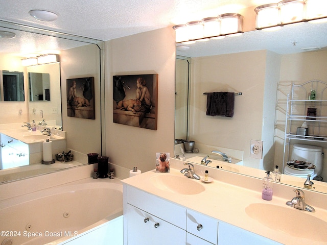 bathroom featuring vanity, a tub to relax in, and a textured ceiling