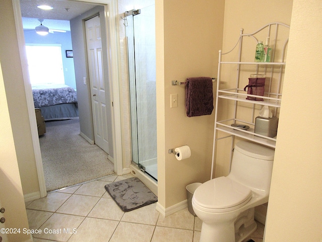 bathroom featuring toilet, tile patterned floors, and walk in shower