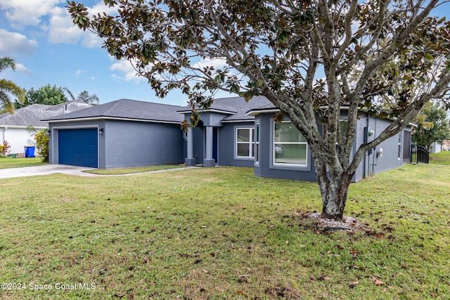 ranch-style home featuring a garage and a front lawn