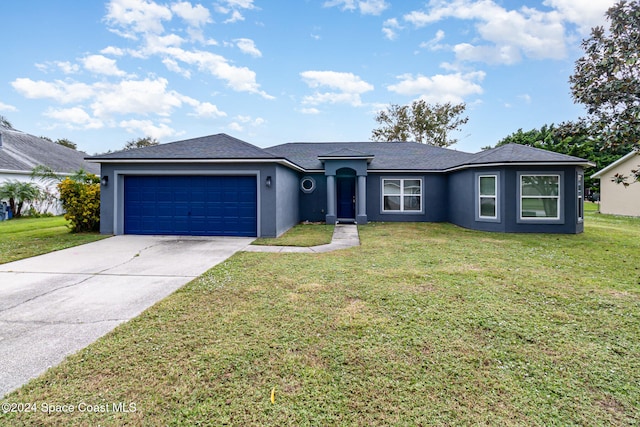 ranch-style house featuring a garage and a front yard