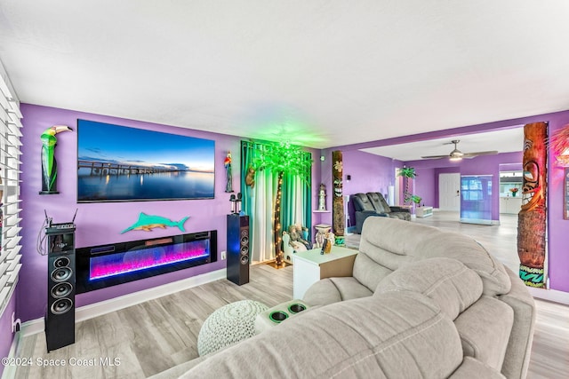 living room featuring ceiling fan and wood-type flooring