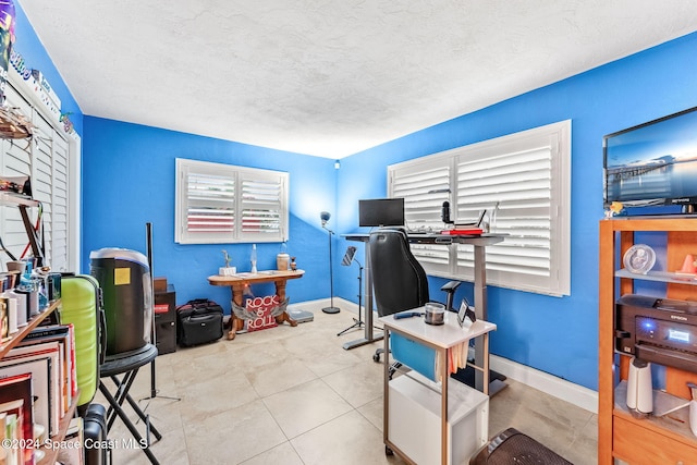 tiled office space with a textured ceiling