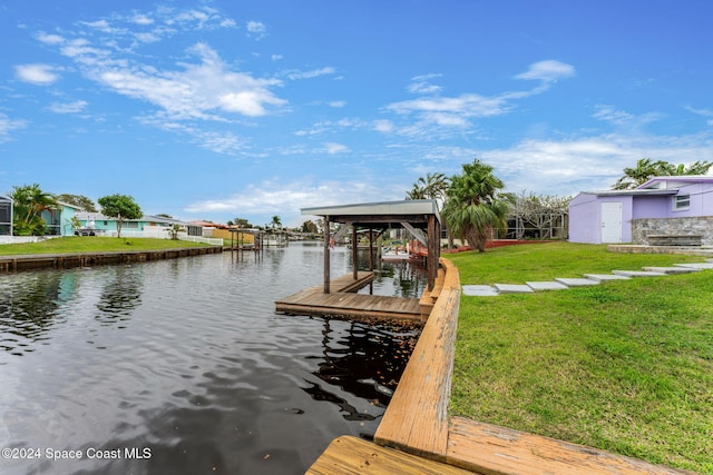 dock area featuring a lawn and a water view