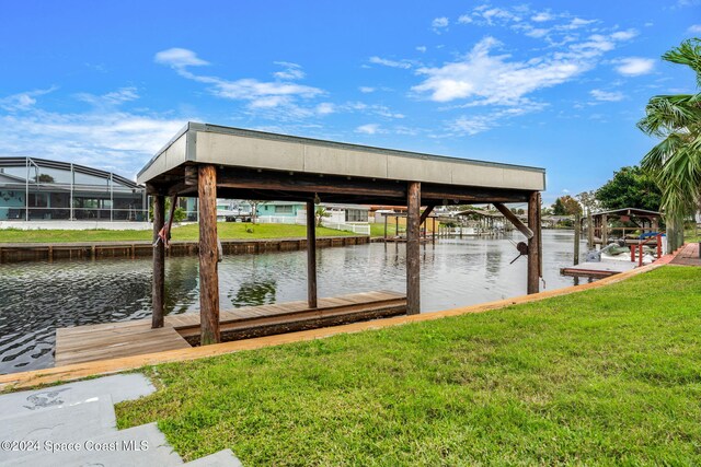 view of dock featuring a yard and a water view