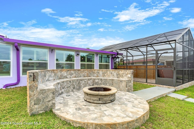 view of patio / terrace with a lanai and an outdoor fire pit