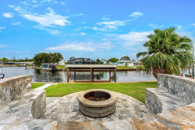 view of patio / terrace with a water view and a dock