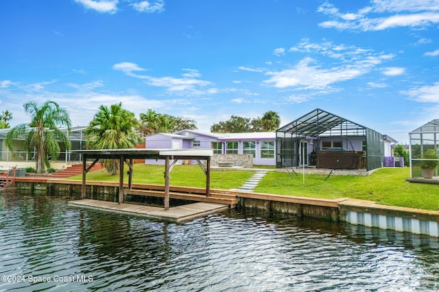 view of dock with glass enclosure, a water view, and a yard