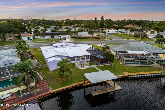 aerial view at dusk with a water view