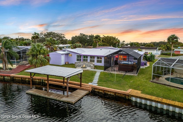 dock area with a yard, a pool with hot tub, a lanai, a water view, and a patio