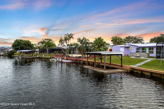 dock area featuring a yard and a water view