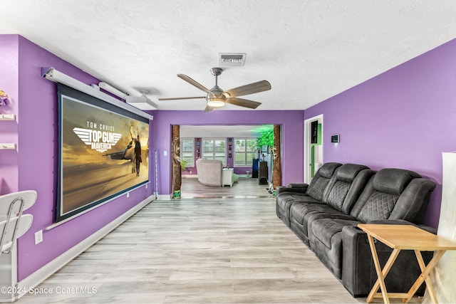 living room with light hardwood / wood-style flooring and ceiling fan