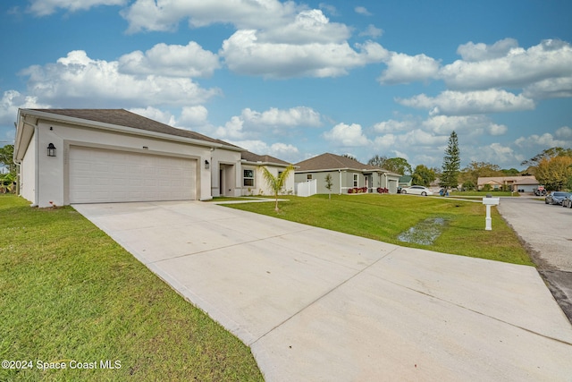 view of front facade featuring a front yard and a garage