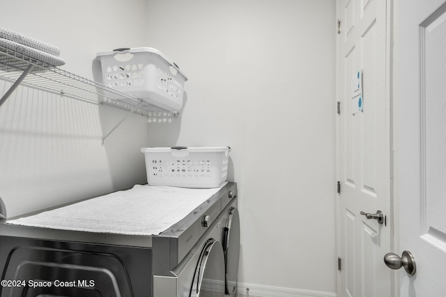 laundry area with washing machine and clothes dryer