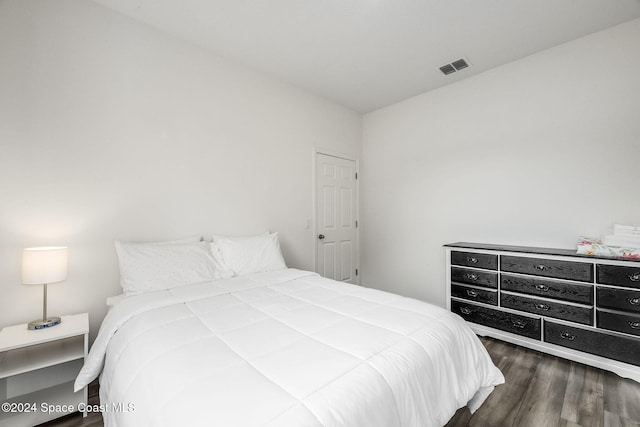 bedroom with dark wood-type flooring