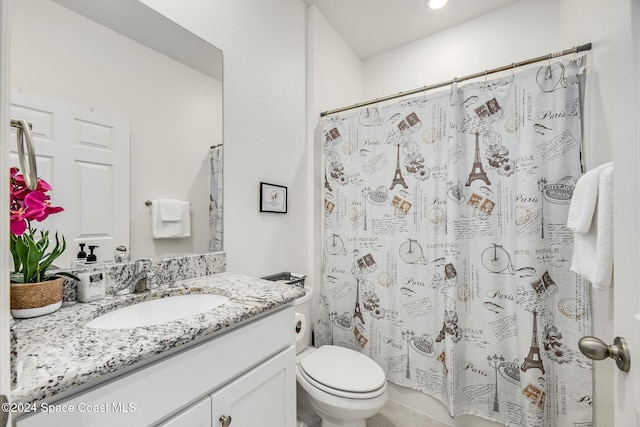 bathroom with walk in shower, vanity, and toilet