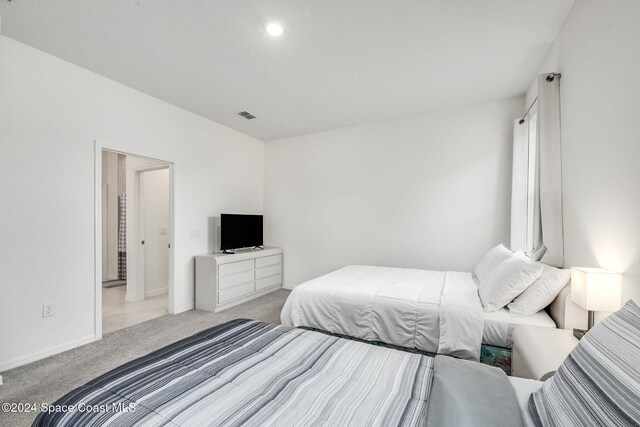 bedroom featuring light colored carpet