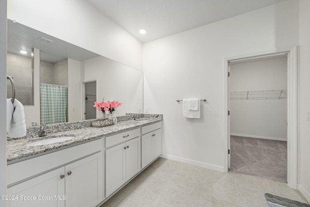 bathroom with tile patterned flooring, vanity, and a shower with curtain