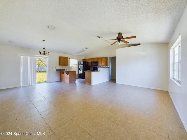 unfurnished living room featuring ceiling fan with notable chandelier, a textured ceiling, light tile patterned floors, and lofted ceiling