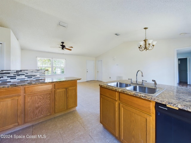 kitchen with sink, tasteful backsplash, a textured ceiling, hanging light fixtures, and vaulted ceiling