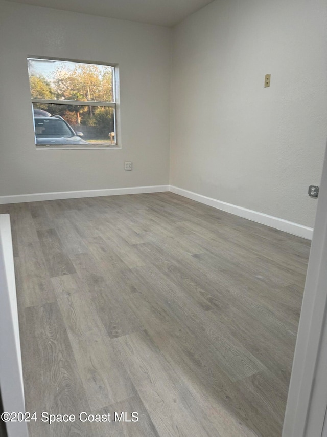 unfurnished room with hardwood / wood-style floors