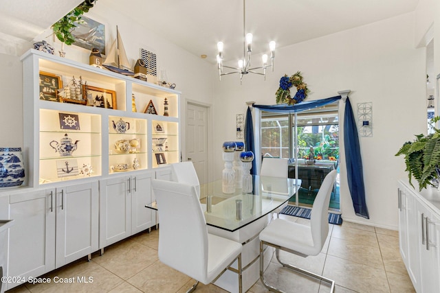 dining room with light tile patterned floors and a notable chandelier