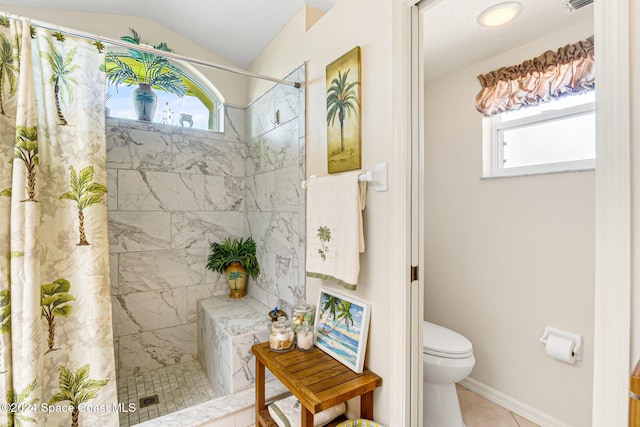 bathroom with a shower with shower curtain, tile patterned floors, toilet, and vaulted ceiling