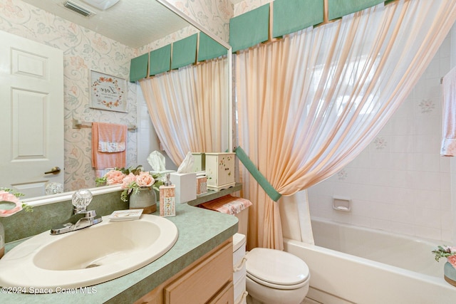 full bathroom with toilet, vanity, and shower / bath combo with shower curtain