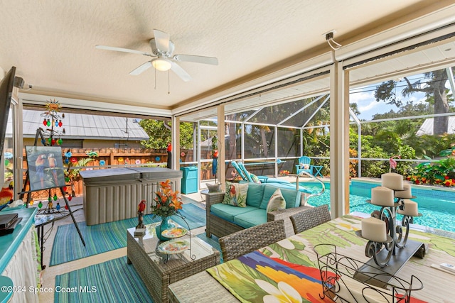 sunroom featuring ceiling fan