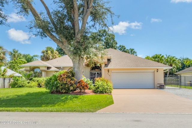 view of front of home featuring a garage and a front yard