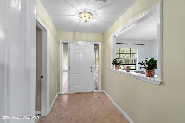 entrance foyer featuring light tile patterned flooring