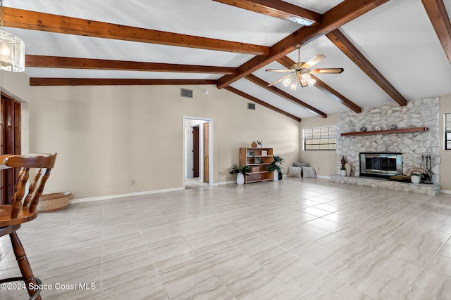 tiled living room with a stone fireplace, ceiling fan, and vaulted ceiling with beams