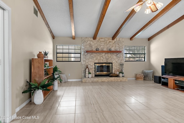 living room featuring vaulted ceiling with beams, light tile patterned floors, ceiling fan, and a fireplace