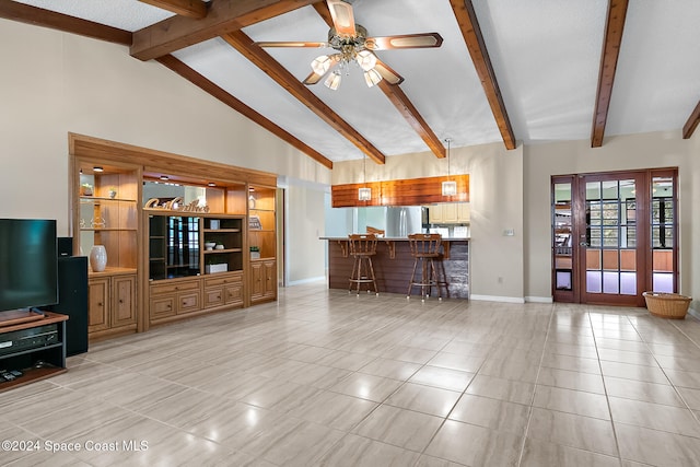 tiled living room with bar area, high vaulted ceiling, beamed ceiling, and ceiling fan