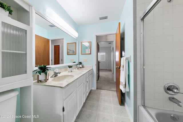 full bathroom with toilet, tiled shower / bath combo, and vanity