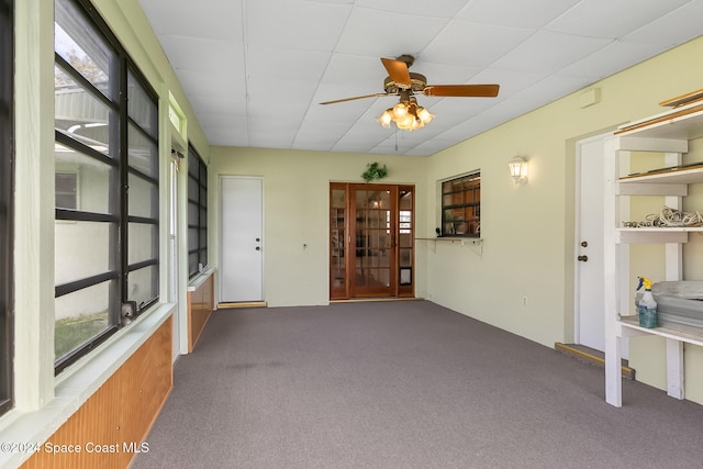 unfurnished sunroom with ceiling fan