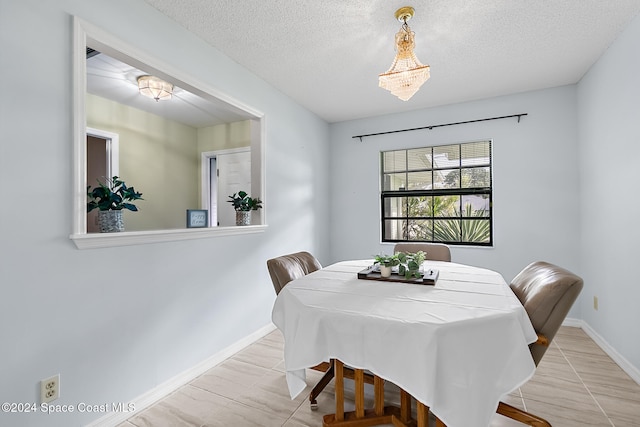 dining space featuring a textured ceiling