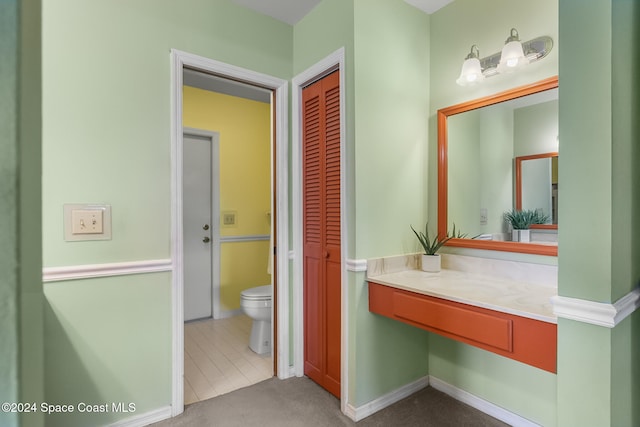 bathroom featuring toilet, vanity, and tile patterned floors