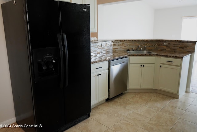 kitchen with dishwasher, decorative backsplash, black refrigerator with ice dispenser, and sink