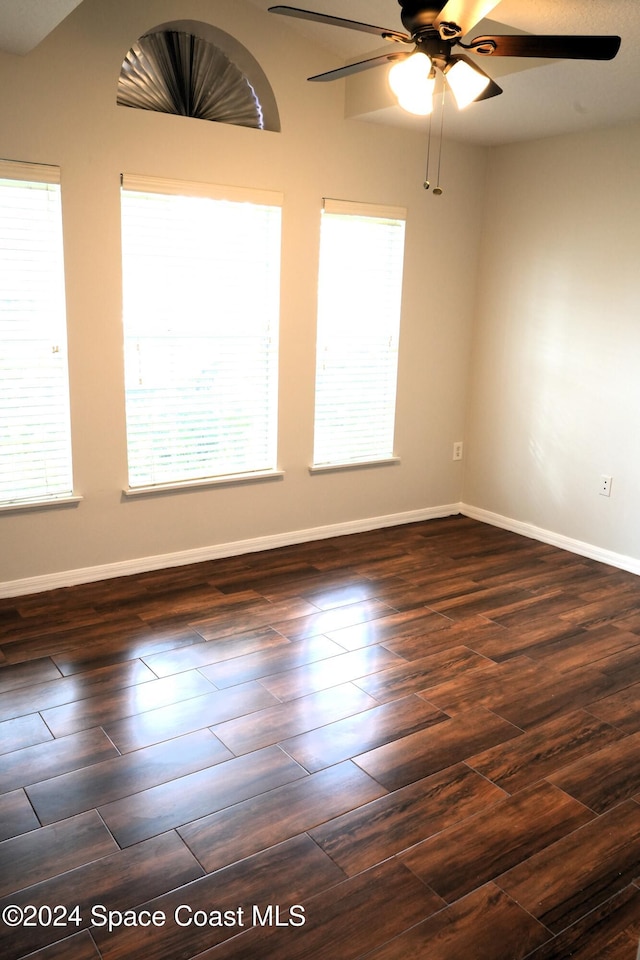 empty room featuring dark wood-type flooring and ceiling fan