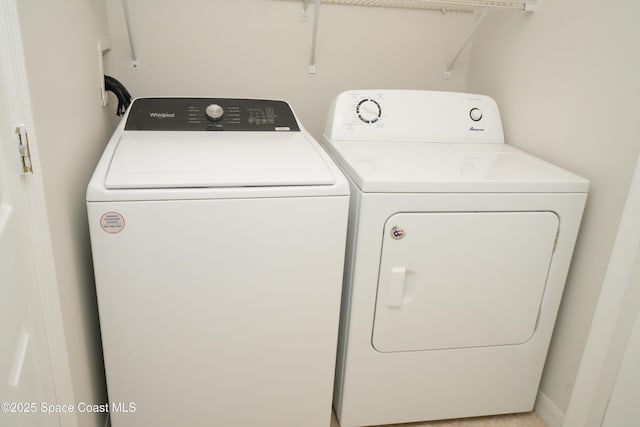 clothes washing area featuring laundry area and washing machine and clothes dryer