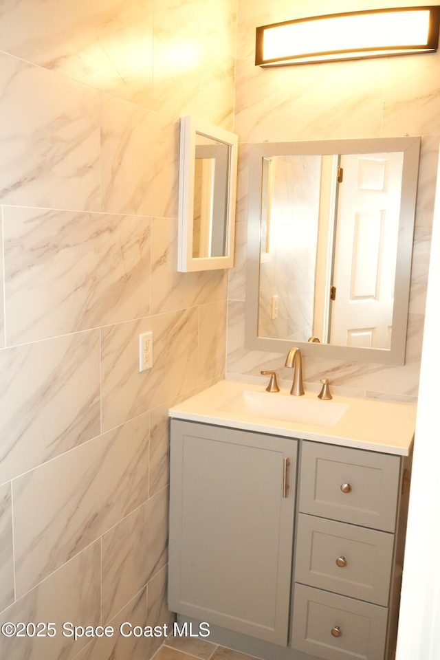 bathroom with tile walls and vanity