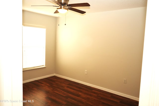 unfurnished room featuring a ceiling fan, dark wood finished floors, and baseboards