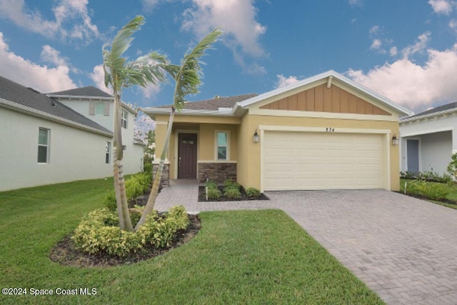 view of front of house with a garage and a front yard